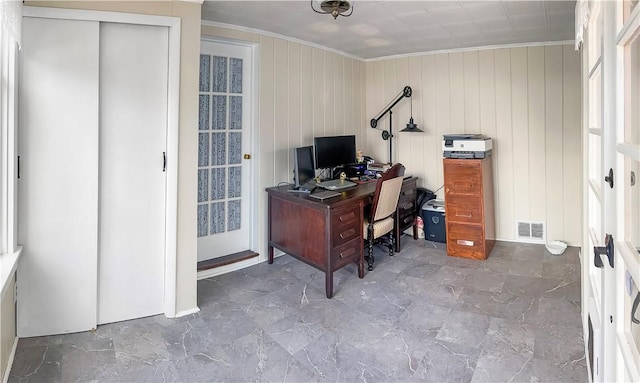 office space with wood walls and crown molding