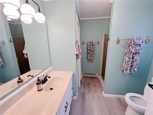 bathroom featuring walk in shower, vanity, crown molding, a baseboard heating unit, and hardwood / wood-style floors