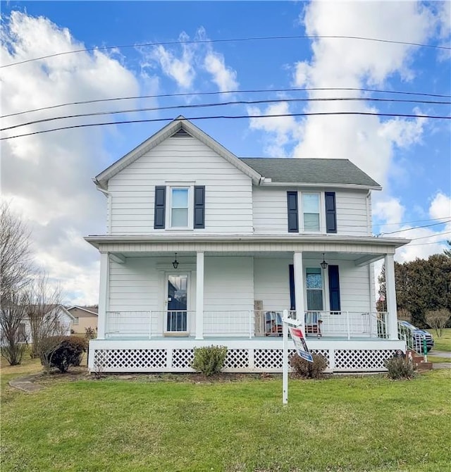 view of front facade with covered porch and a front lawn