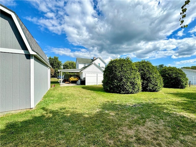 view of yard with a carport and a storage shed