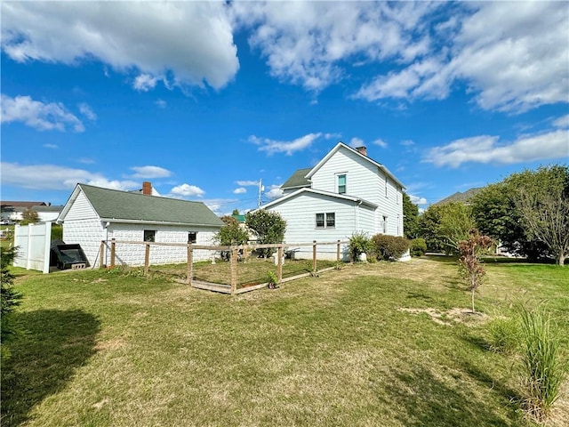 view of side of property with a yard