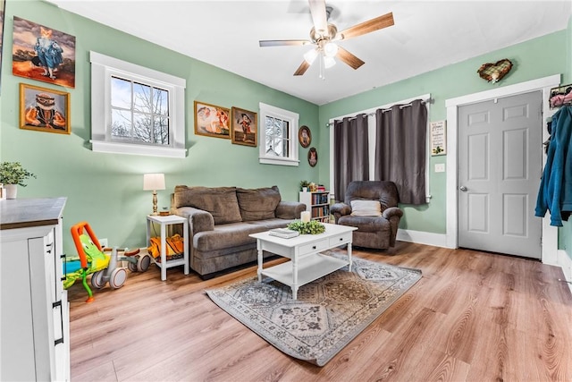 living room featuring ceiling fan and light hardwood / wood-style floors