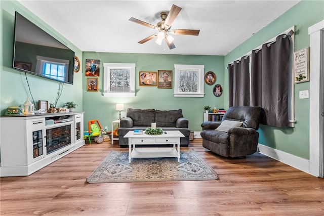 living room with ceiling fan and light hardwood / wood-style floors