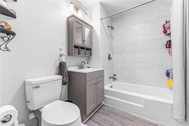 full bathroom featuring vanity, wood-type flooring, shower / bath combo, and toilet