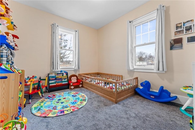 bedroom with a crib and carpet floors