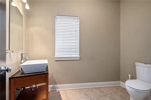 bathroom with tile patterned floors, vanity, and toilet