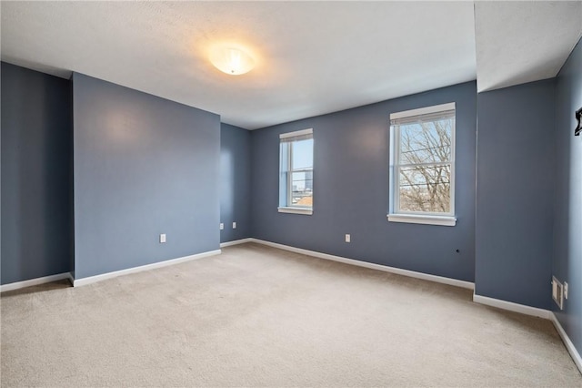 unfurnished room featuring light colored carpet