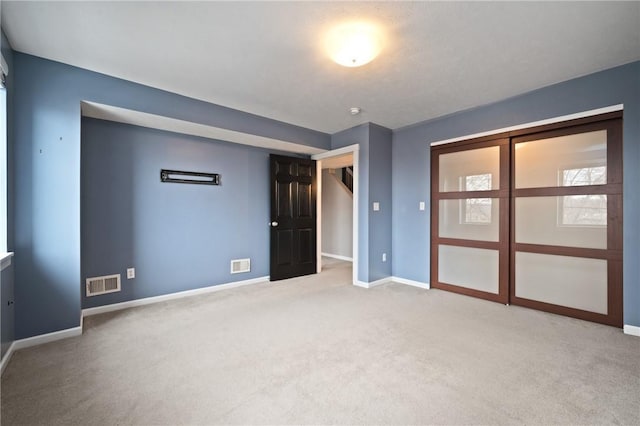 unfurnished bedroom featuring light colored carpet