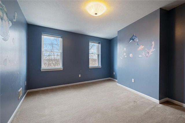 unfurnished room featuring light colored carpet