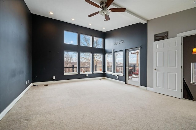 carpeted spare room with ceiling fan