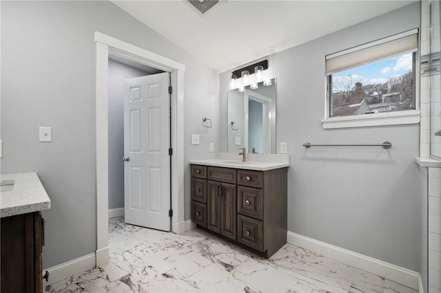 bathroom featuring vanity and vaulted ceiling