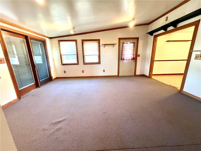 carpeted spare room featuring lofted ceiling and crown molding