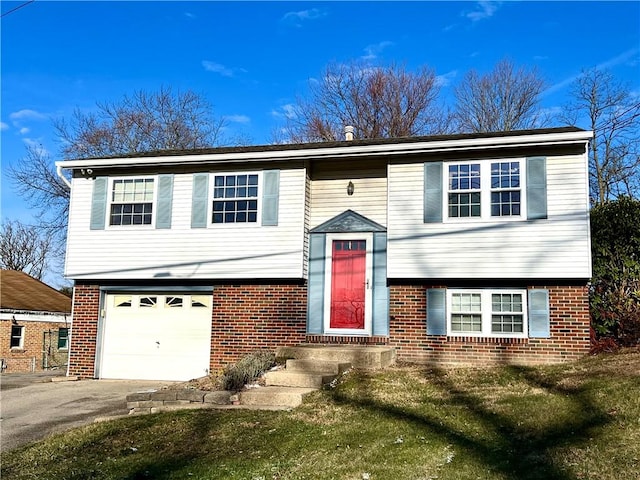 bi-level home featuring a garage and a front yard