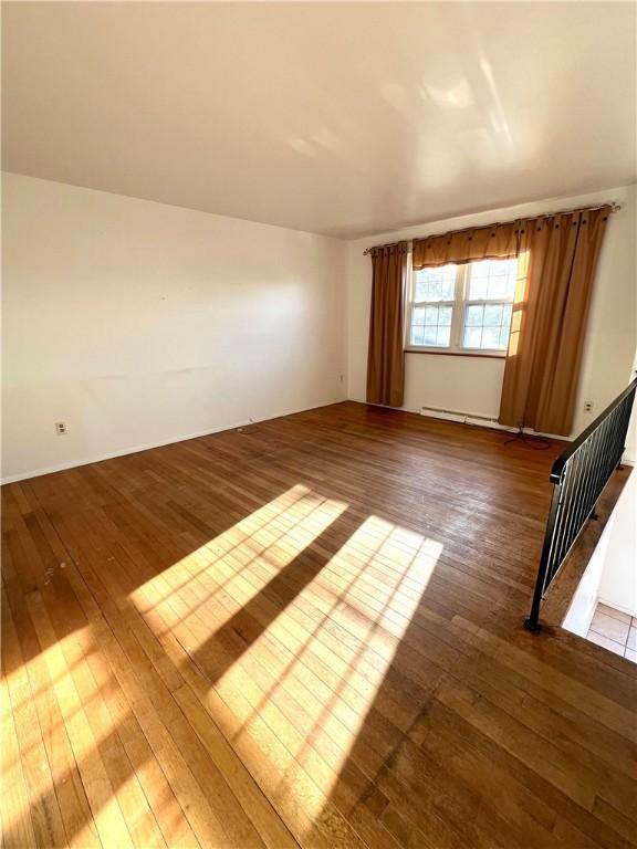 spare room with dark hardwood / wood-style flooring