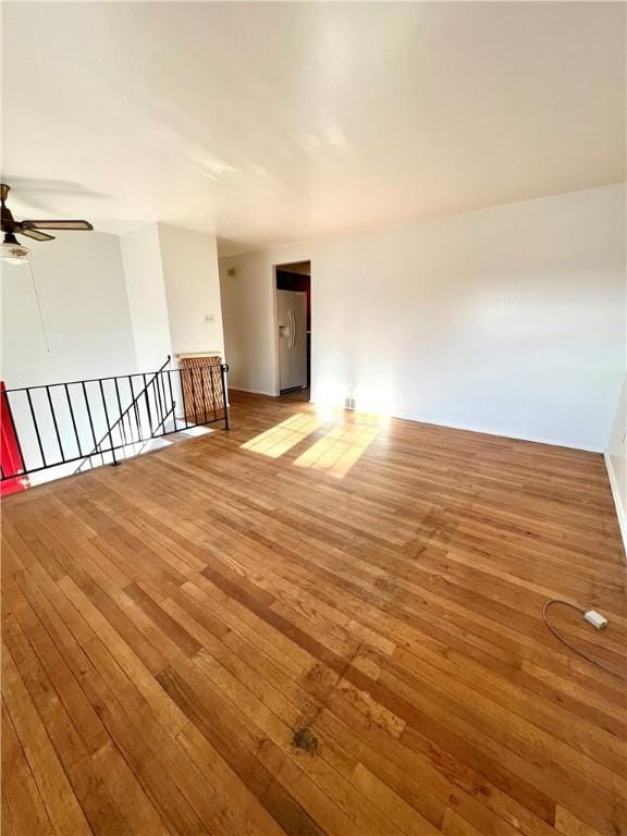 spare room with ceiling fan and hardwood / wood-style flooring