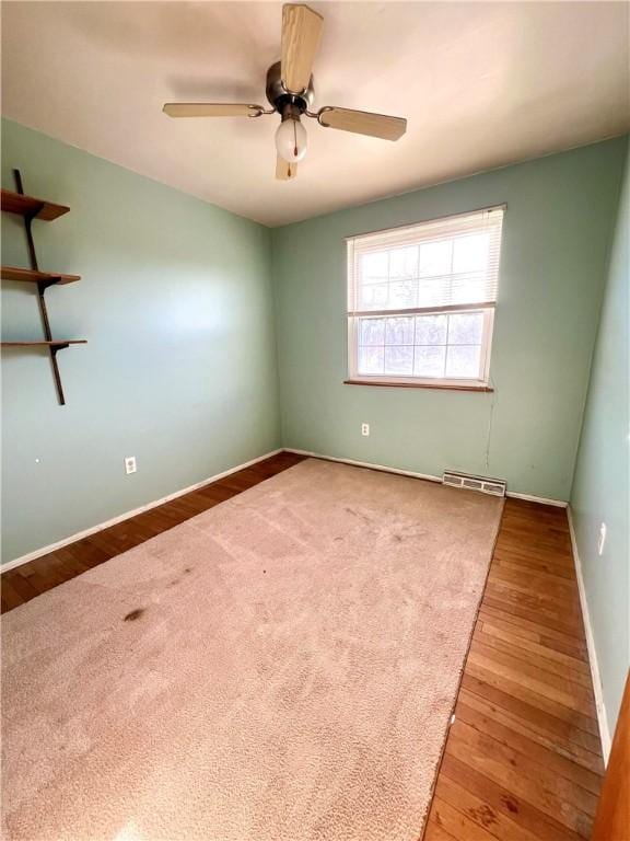 empty room with light hardwood / wood-style floors and ceiling fan