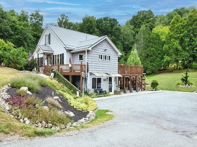 view of front of home with a front lawn and a deck