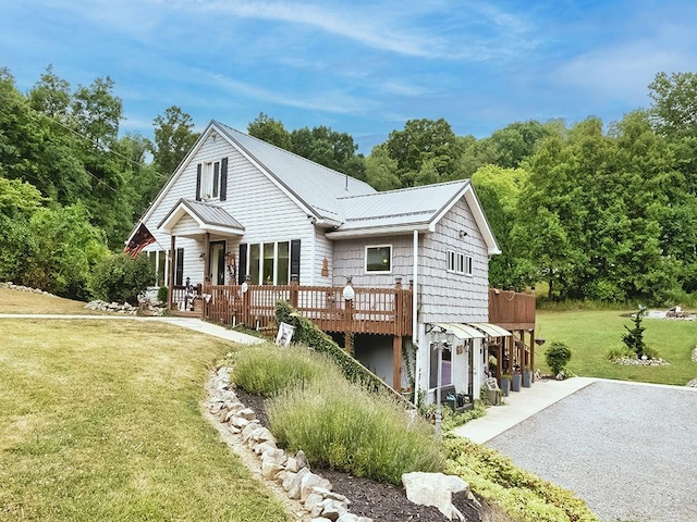 exterior space with a wooden deck and a front lawn