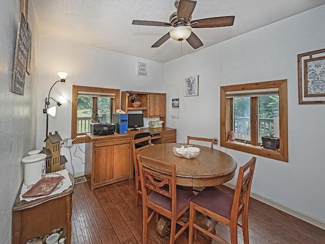 dining area with ceiling fan and dark wood-type flooring