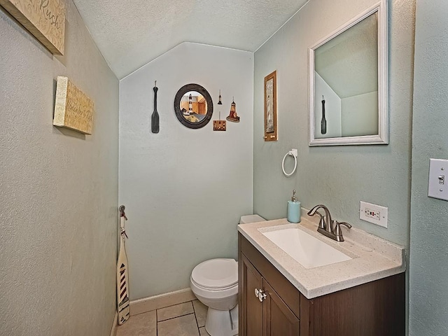 bathroom featuring tile patterned floors, lofted ceiling, a textured ceiling, toilet, and vanity