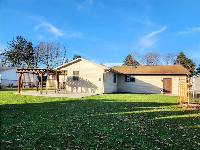 rear view of house featuring a pergola, a yard, and a patio