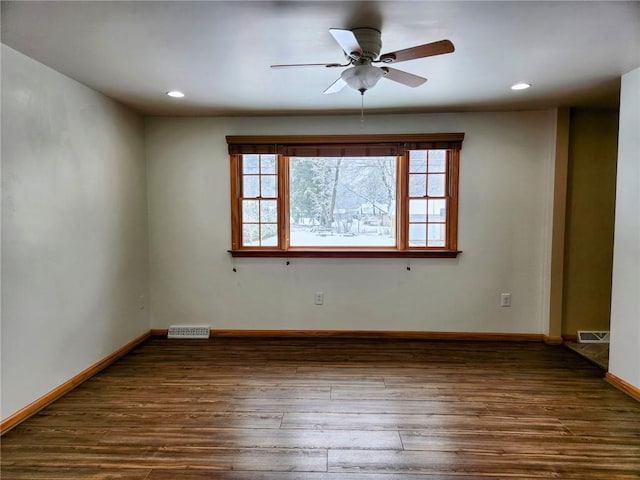 unfurnished room featuring ceiling fan and dark hardwood / wood-style flooring