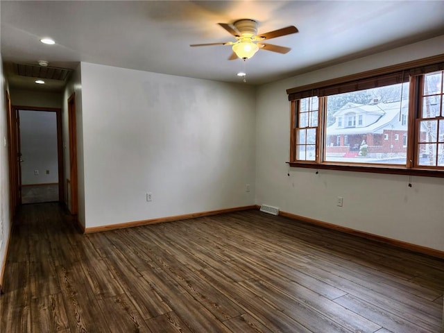 spare room with dark hardwood / wood-style floors and ceiling fan