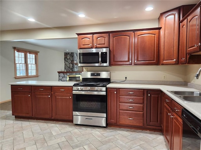 kitchen with kitchen peninsula, stainless steel appliances, and sink