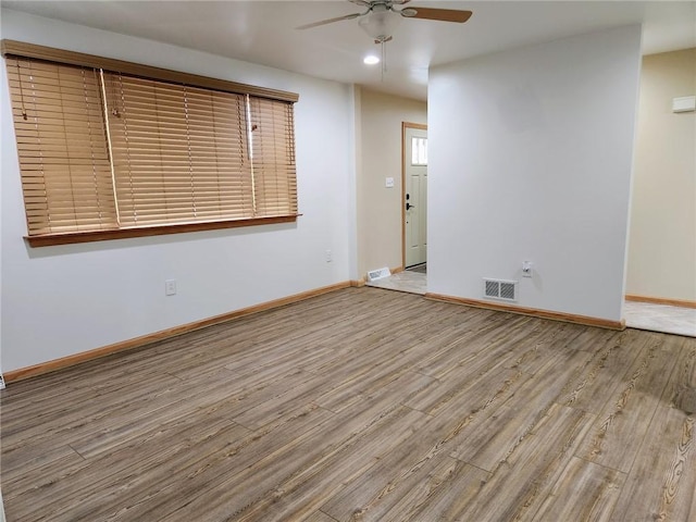 unfurnished room with ceiling fan and light hardwood / wood-style flooring