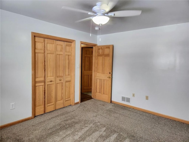 unfurnished bedroom with carpet, ceiling fan, and a closet