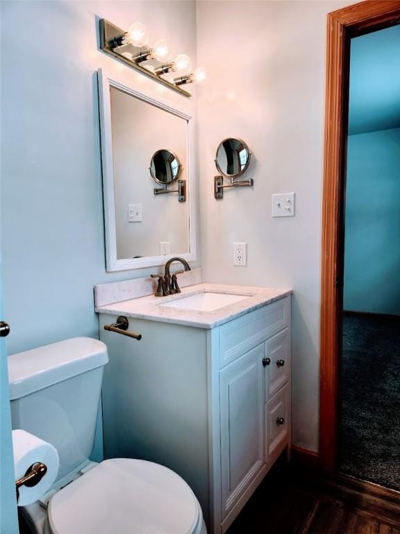 bathroom featuring vanity and toilet