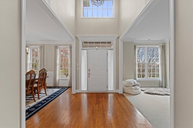 foyer entrance with wood-type flooring and a notable chandelier