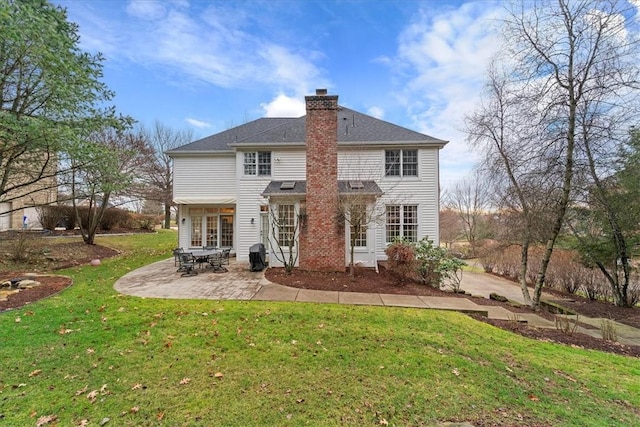 rear view of property with a patio and a lawn