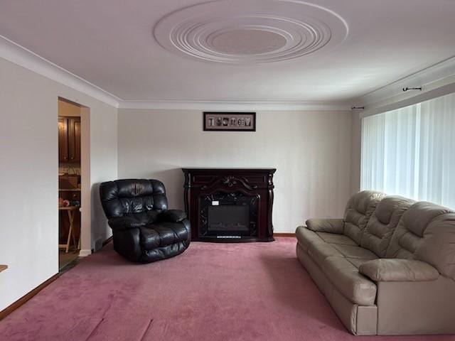 carpeted living room featuring crown molding