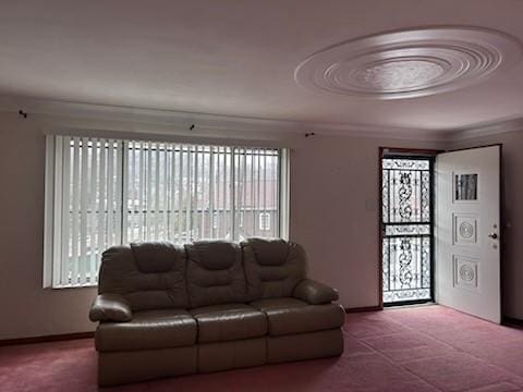 living room with carpet and ornamental molding