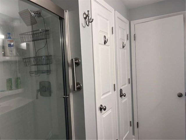 bathroom with a shower with shower door