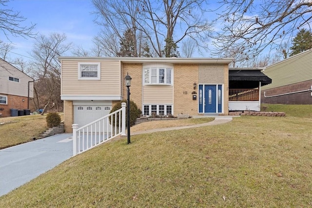 bi-level home with a garage and a front lawn