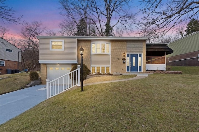 bi-level home with a lawn and a garage