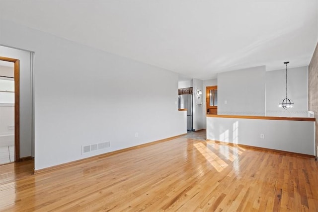 unfurnished room with light hardwood / wood-style floors