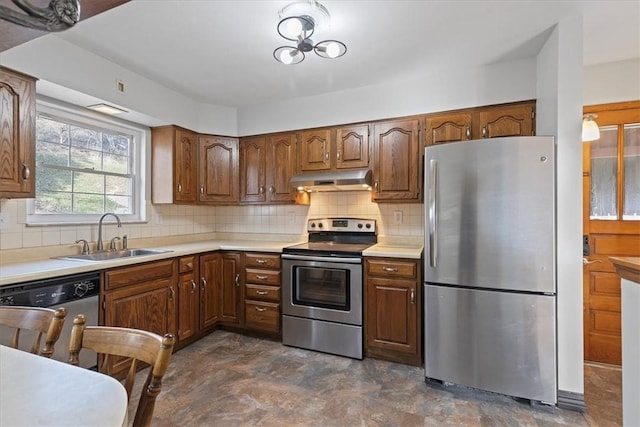 kitchen featuring backsplash, sink, and appliances with stainless steel finishes