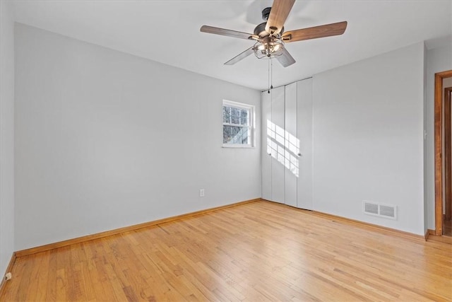 empty room featuring ceiling fan and light hardwood / wood-style flooring