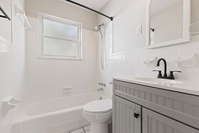 full bathroom featuring tile patterned floors, tiled shower / bath combo, toilet, tile walls, and tasteful backsplash