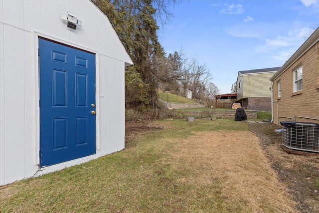 view of yard featuring cooling unit and a storage unit