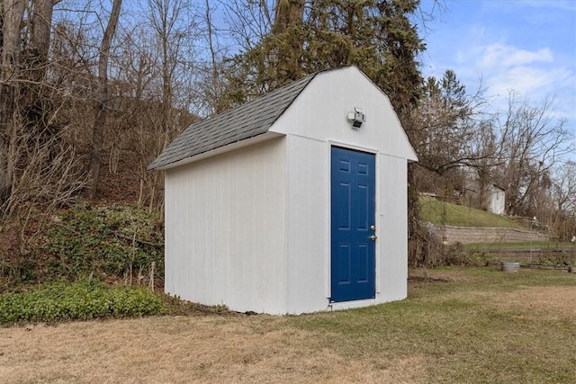 view of outbuilding with a yard