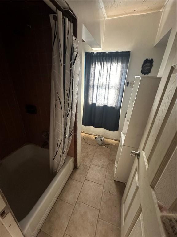 bathroom featuring tile patterned flooring and shower / bath combo with shower curtain