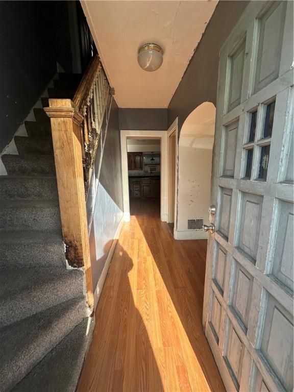 stairs featuring hardwood / wood-style floors