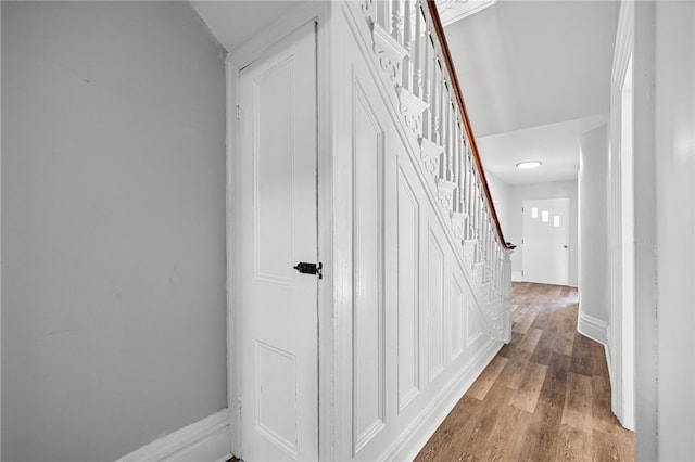 stairway with hardwood / wood-style flooring