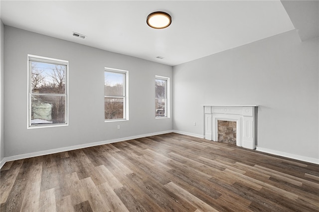 unfurnished living room with hardwood / wood-style flooring and plenty of natural light