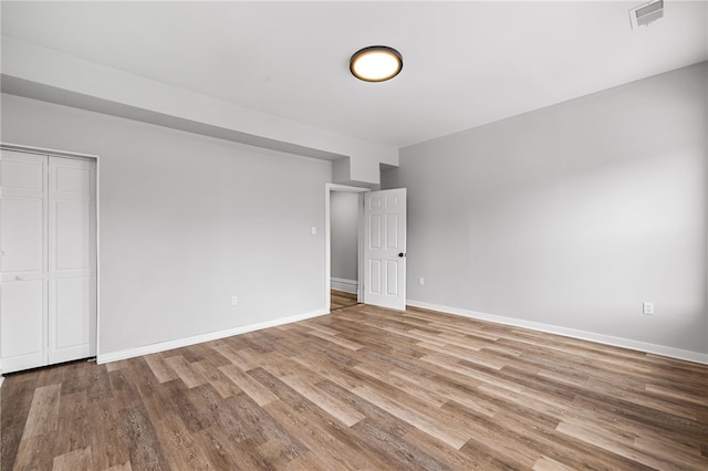 unfurnished bedroom with a closet and light wood-type flooring