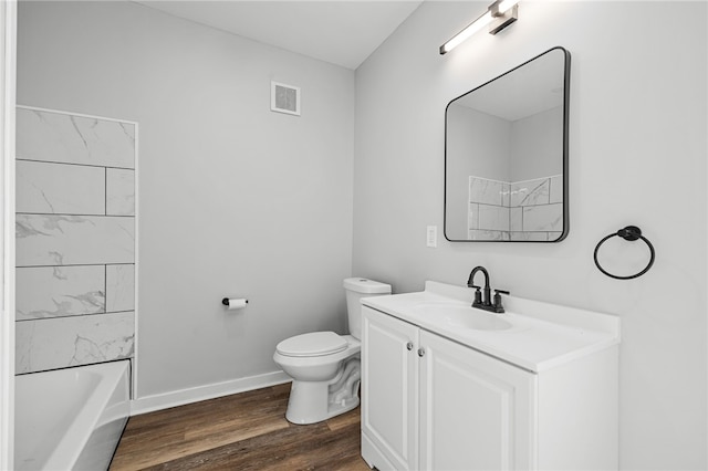 full bathroom featuring vanity, wood-type flooring, bathtub / shower combination, and toilet